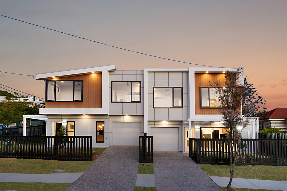 This is an example of a multi-coloured modern two floor terraced house in Brisbane with wood cladding, a flat roof and a metal roof.