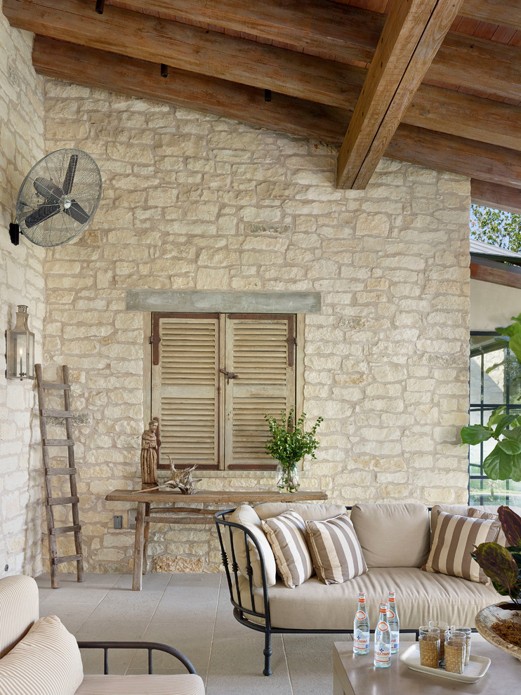 This is an example of a mediterranean verandah in Austin with a roof extension.
