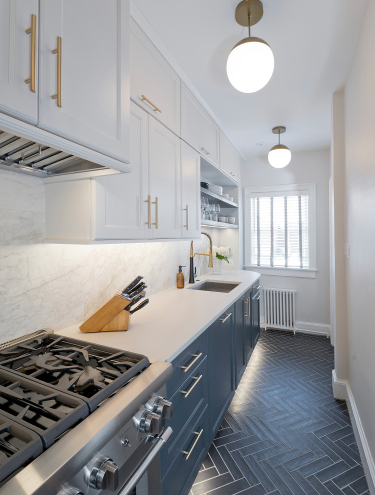This is an example of a small traditional single-wall separate kitchen in DC Metro with an undermount sink, shaker cabinets, blue cabinets, quartz benchtops, white splashback, porcelain splashback, stainless steel appliances, ceramic floors, no island, black floor and white benchtop.