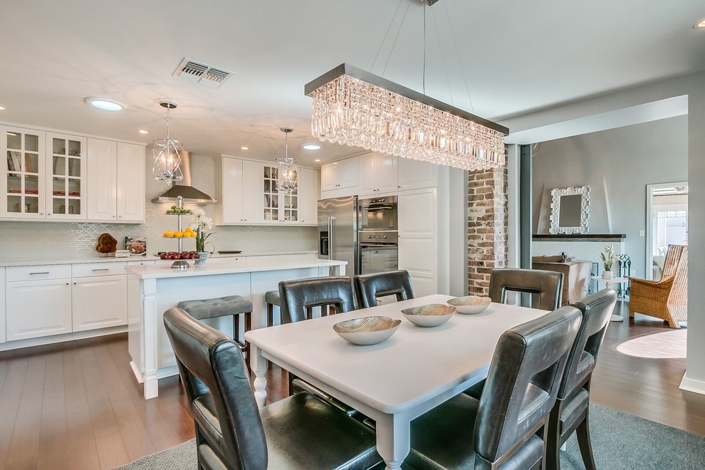 Example of a mid-sized transitional medium tone wood floor and brown floor kitchen/dining room combo design in Phoenix with white walls and no fireplace