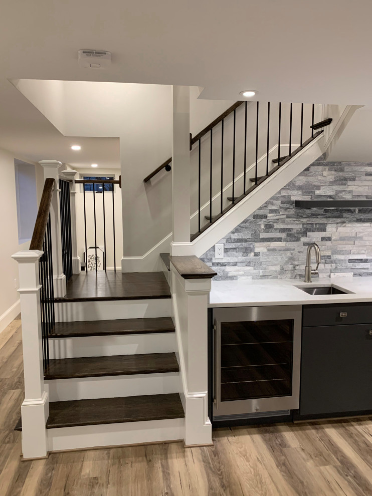 This is an example of a mid-sized transitional wood l-shaped staircase in Boston with painted wood risers and mixed railing.