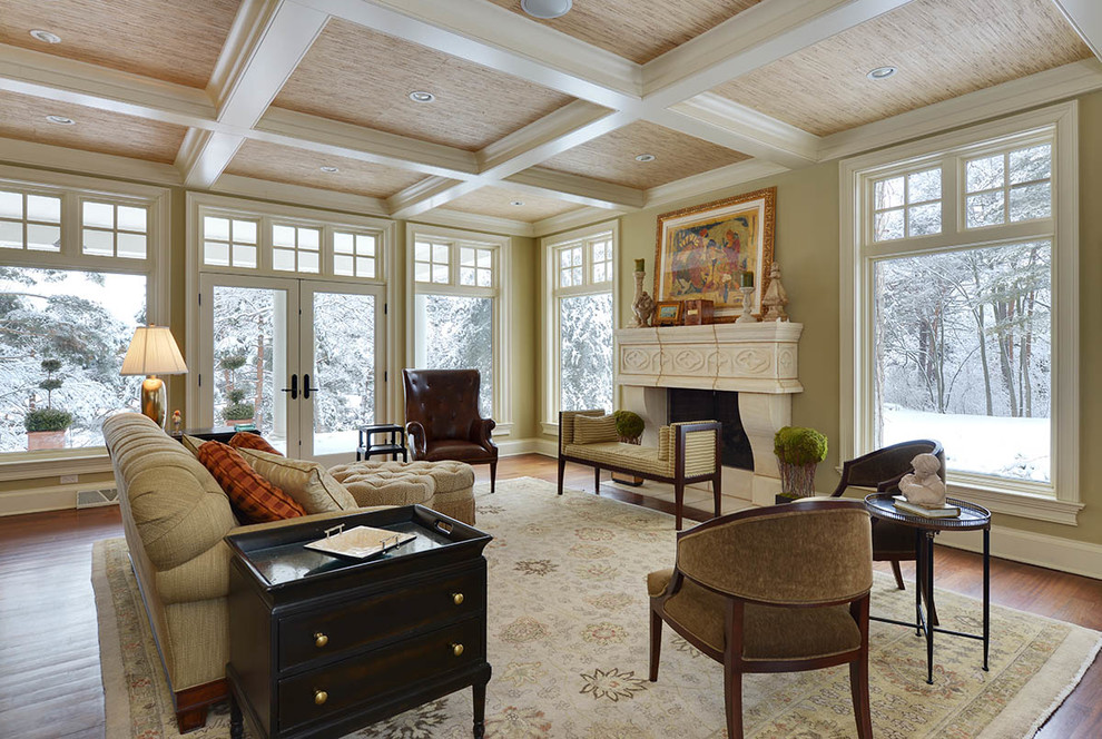 This is an example of a mid-sized arts and crafts formal open concept living room in Milwaukee with beige walls, dark hardwood floors, a standard fireplace, a stone fireplace surround and no tv.