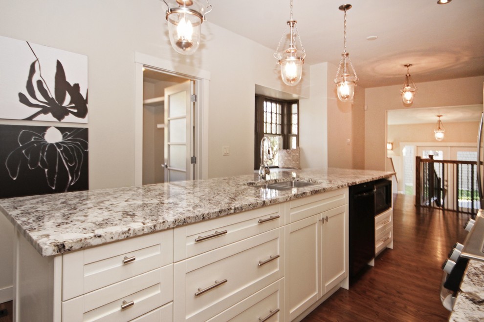 Mid-sized transitional single-wall medium tone wood floor eat-in kitchen photo in Calgary with a double-bowl sink, white cabinets, granite countertops, stainless steel appliances and an island