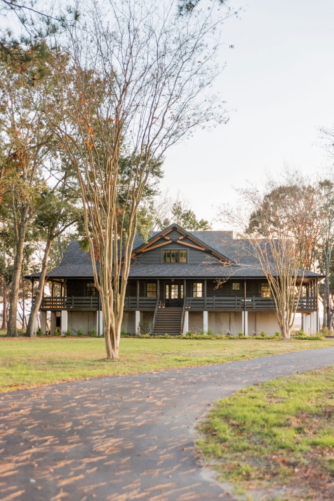 Example of a country black two-story wood gable roof design in Charleston with a shingle roof