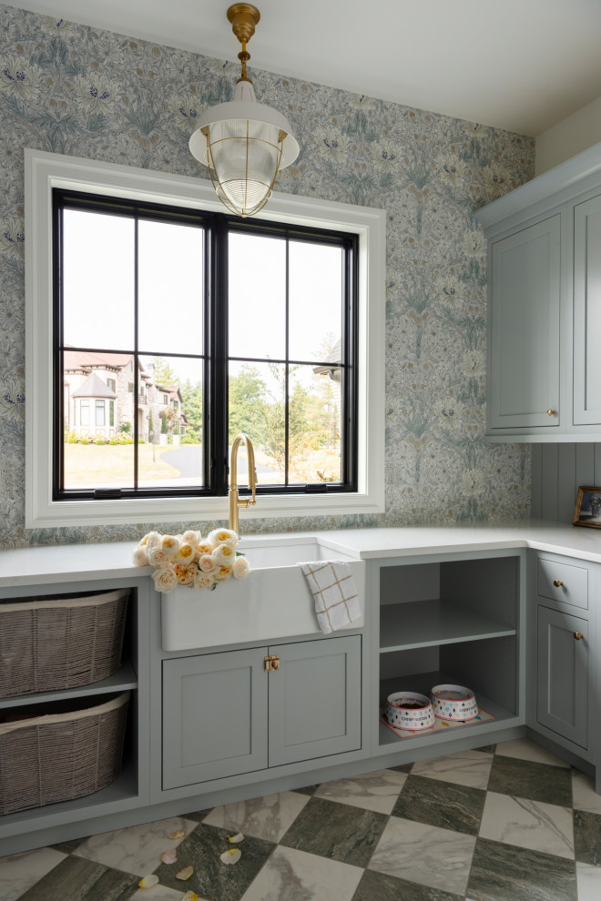 Dedicated laundry room - large transitional u-shaped porcelain tile, multicolored floor and wallpaper dedicated laundry room idea in St Louis with a farmhouse sink, flat-panel cabinets, blue cabinets, quartz countertops, blue backsplash, shiplap backsplash, multicolored walls and white countertops