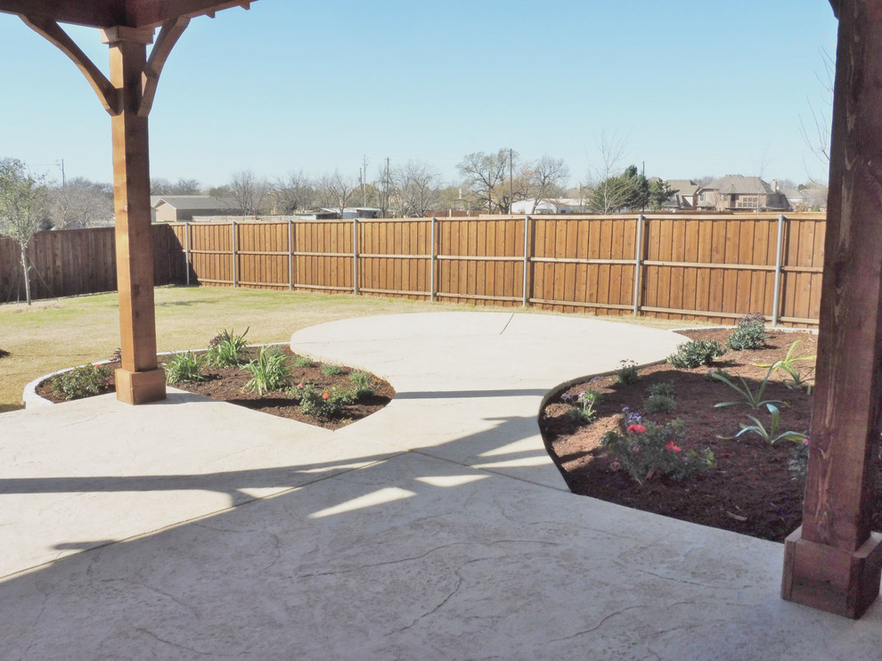 Inspiration for a large country backyard patio in Dallas with an outdoor kitchen and concrete slab.