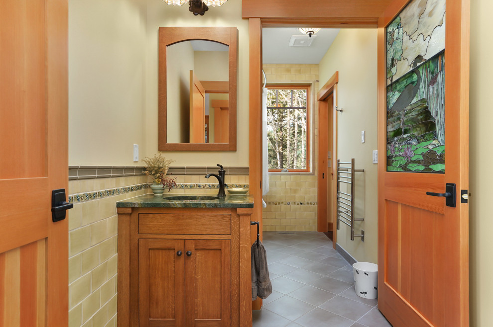 Источник вдохновения для домашнего уюта: ванная комната среднего размера в стиле кантри с фасадами в стиле шейкер, фасадами цвета дерева среднего тона, полновстраиваемой ванной, душем над ванной, зеленой плиткой, керамической плиткой, бежевыми стенами, полом из керамогранита, врезной раковиной, столешницей из гранита, серым полом, шторкой для ванной, зеленой столешницей, нишей, тумбой под одну раковину, встроенной тумбой и панелями на стенах