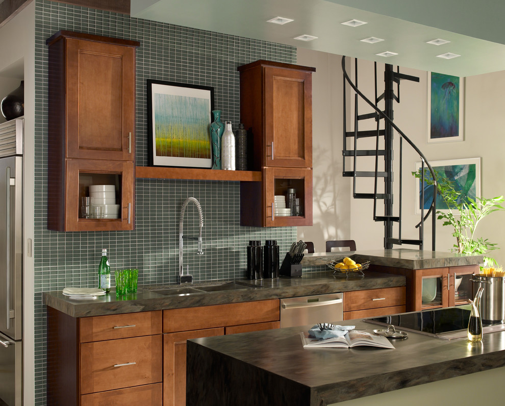Mid-sized transitional kitchen photo with a double-bowl sink, recessed-panel cabinets, medium tone wood cabinets, green backsplash, glass tile backsplash, stainless steel appliances and an island