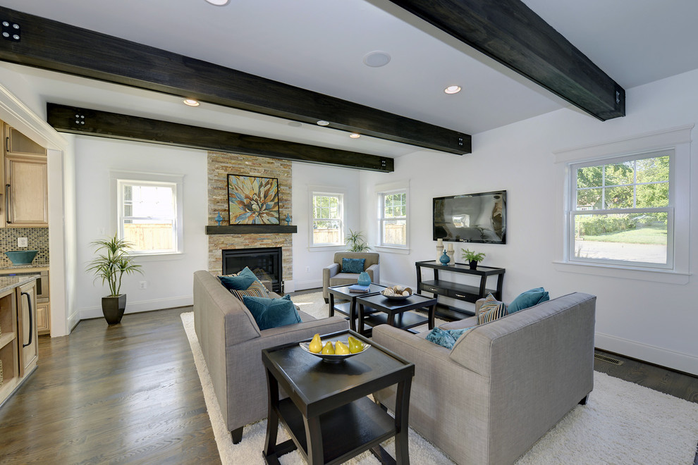 Inspiration for a large transitional open concept family room in DC Metro with white walls, medium hardwood floors, a standard fireplace, a stone fireplace surround and a wall-mounted tv.
