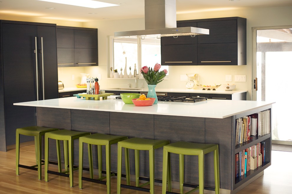 Contemporary kitchen in Salt Lake City with flat-panel cabinets, dark wood cabinets and panelled appliances.
