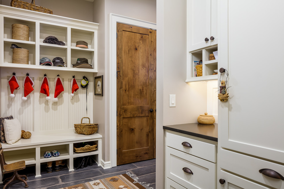 Example of a transitional gray floor entryway design in Other with gray walls and a medium wood front door