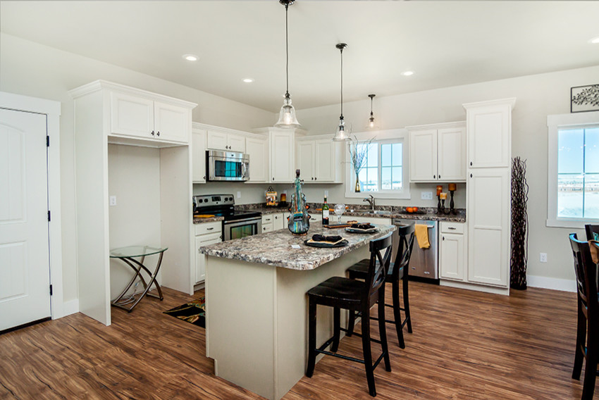 Mid-sized transitional l-shaped medium tone wood floor open concept kitchen photo with an undermount sink, recessed-panel cabinets, white cabinets, granite countertops, stainless steel appliances and an island