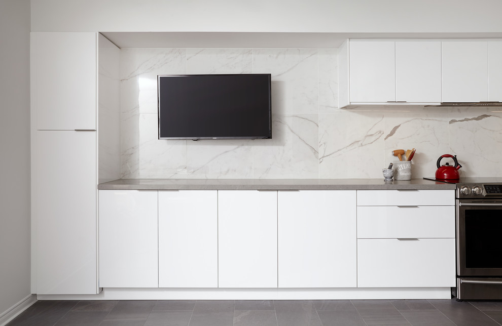 Design ideas for a large modern l-shaped separate kitchen in Toronto with an undermount sink, flat-panel cabinets, white cabinets, solid surface benchtops, white splashback, marble splashback, stainless steel appliances, cement tiles, no island and grey floor.