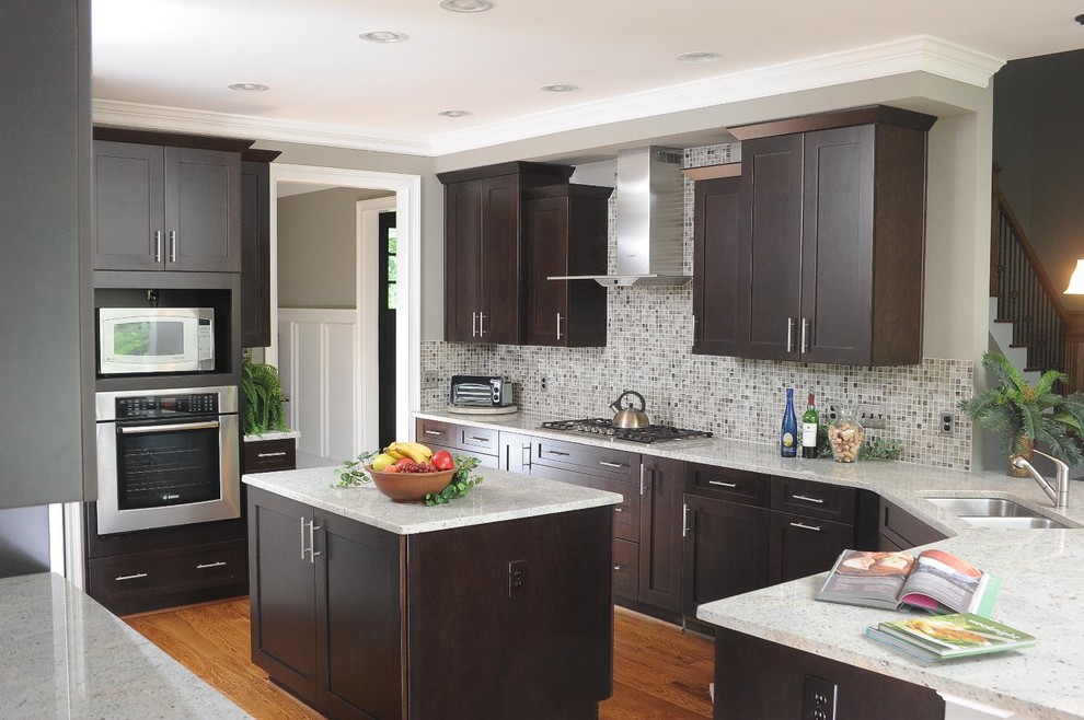 Large transitional u-shaped kitchen in Other with flat-panel cabinets, dark wood cabinets, medium hardwood floors and with island.