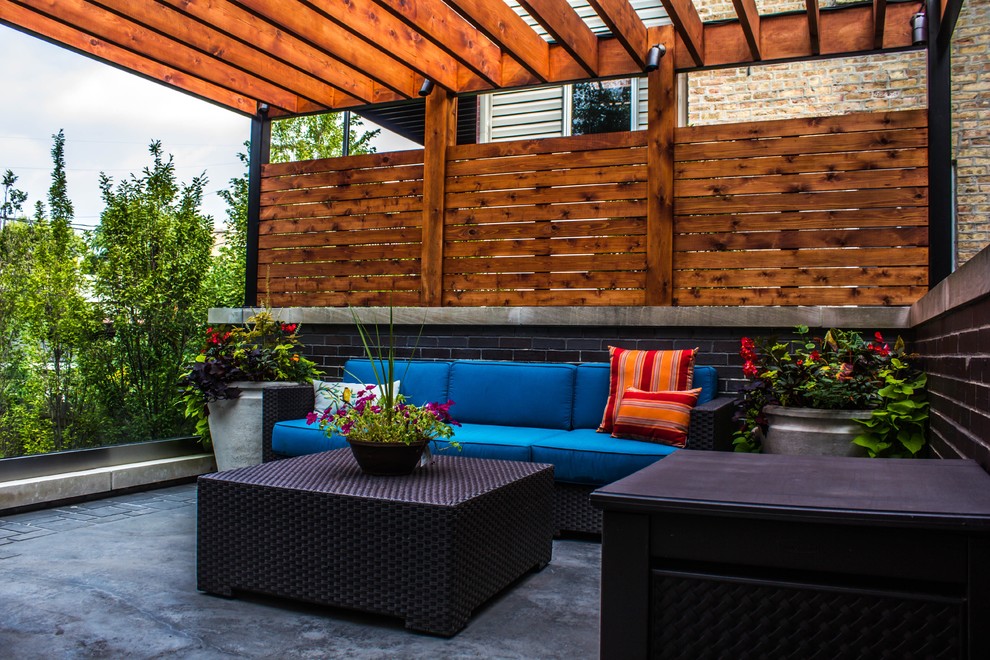 Design ideas for a large contemporary backyard deck in Chicago with an outdoor kitchen and a pergola.