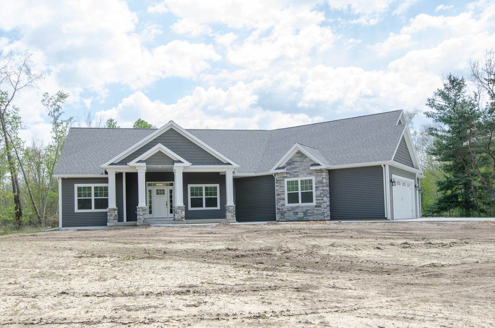 Example of a mid-sized transitional gray one-story mixed siding gable roof design with a shingle roof