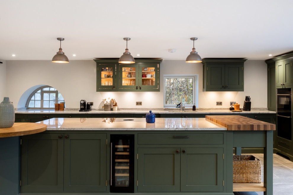 Inspiration for a large country l-shaped open plan kitchen in Sussex with shaker cabinets, green cabinets, granite worktops and an island.