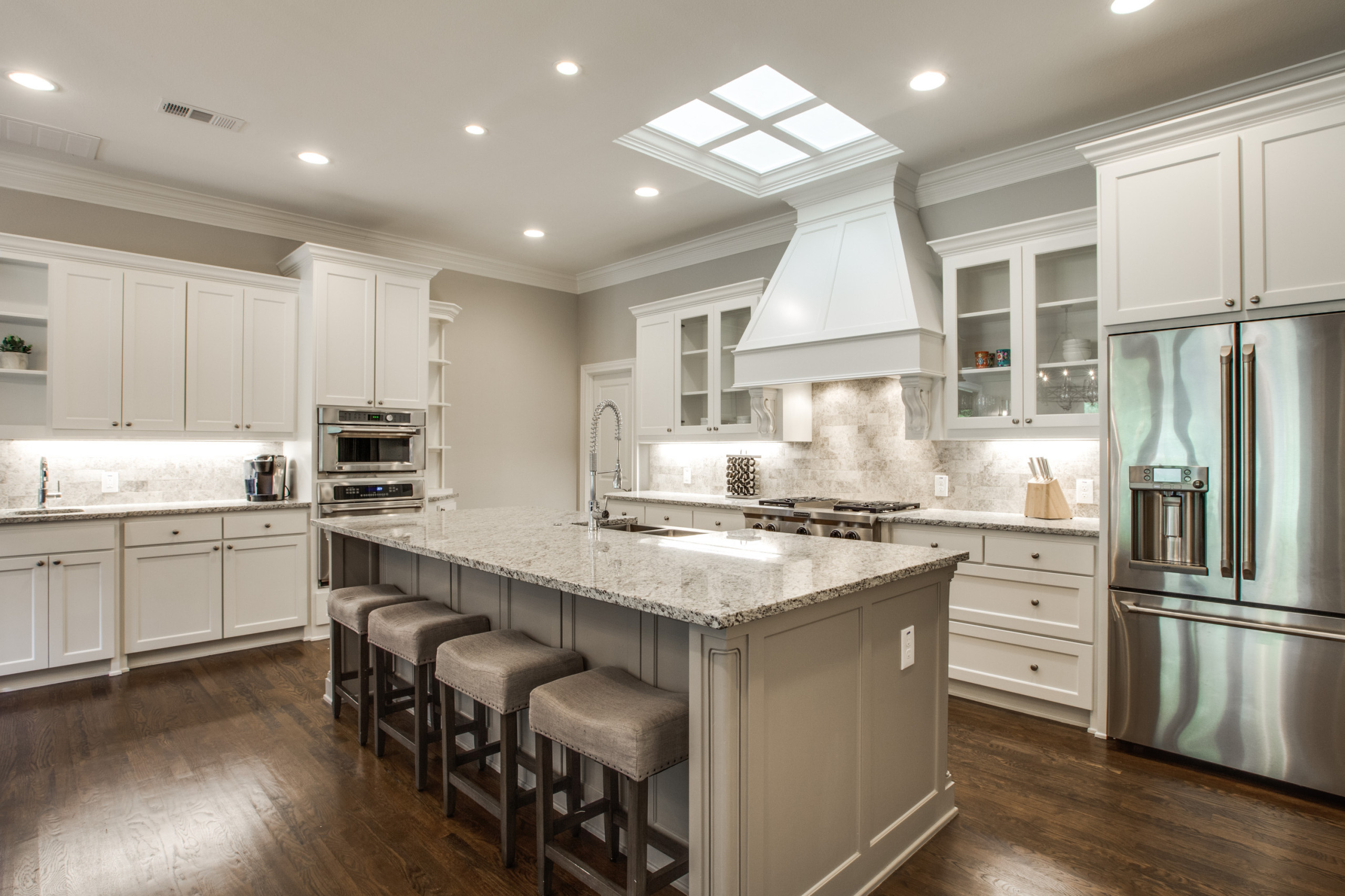 Spacious remodeled custom Kitchen with recessed cabinets, granite countertops and undemount sink, ceramic tile back splash, drop in and in wall stainless steel applicances, professional vent hood and