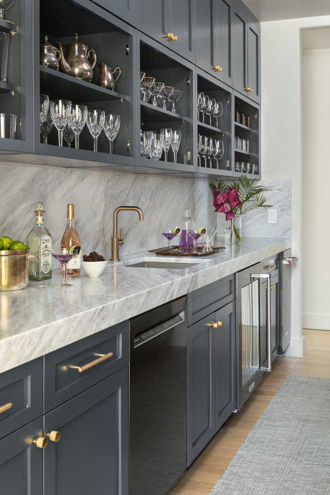 Design ideas for a mid-sized country galley wet bar in Denver with an undermount sink, flat-panel cabinets, blue cabinets, grey splashback, light hardwood floors, brown floor and grey benchtop.