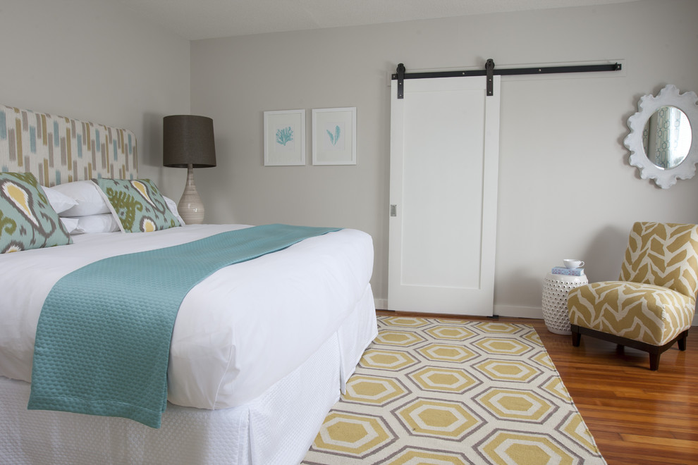 Photo of a transitional bedroom in Providence with grey walls and medium hardwood floors.