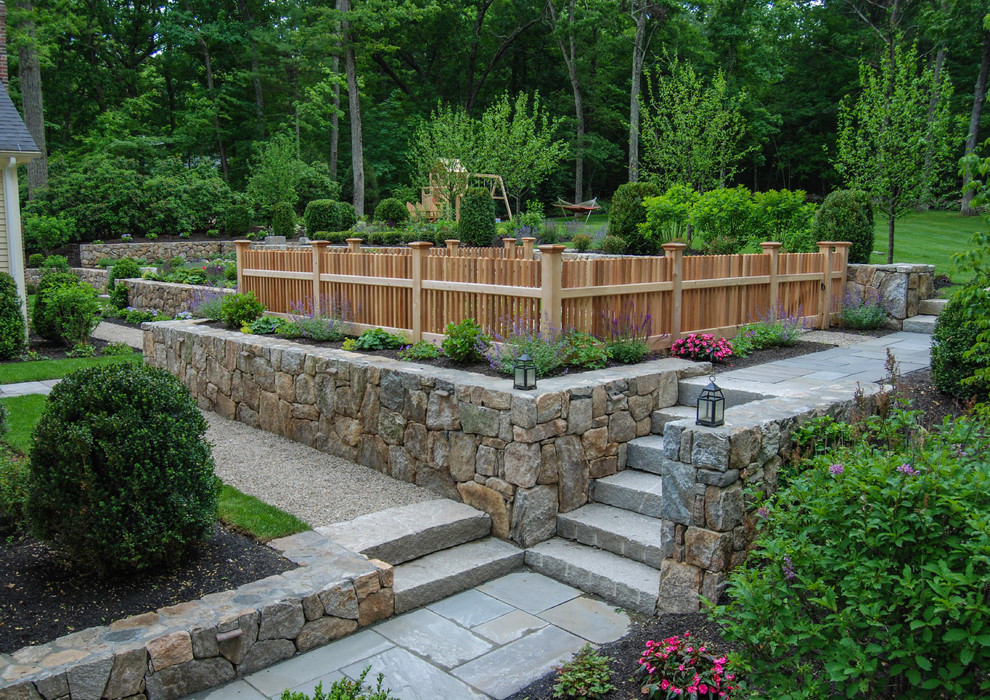 Mid-sized traditional backyard garden in Boston with a retaining wall.