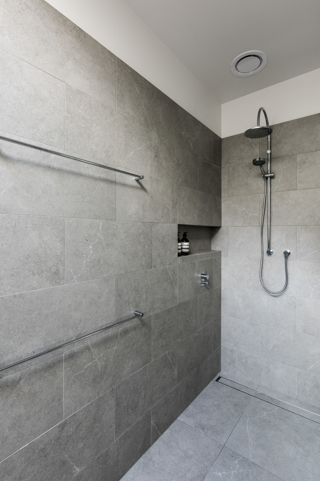 This is an example of a modern master bathroom in Melbourne with a freestanding tub, an open shower, multi-coloured walls, ceramic floors and a vessel sink.