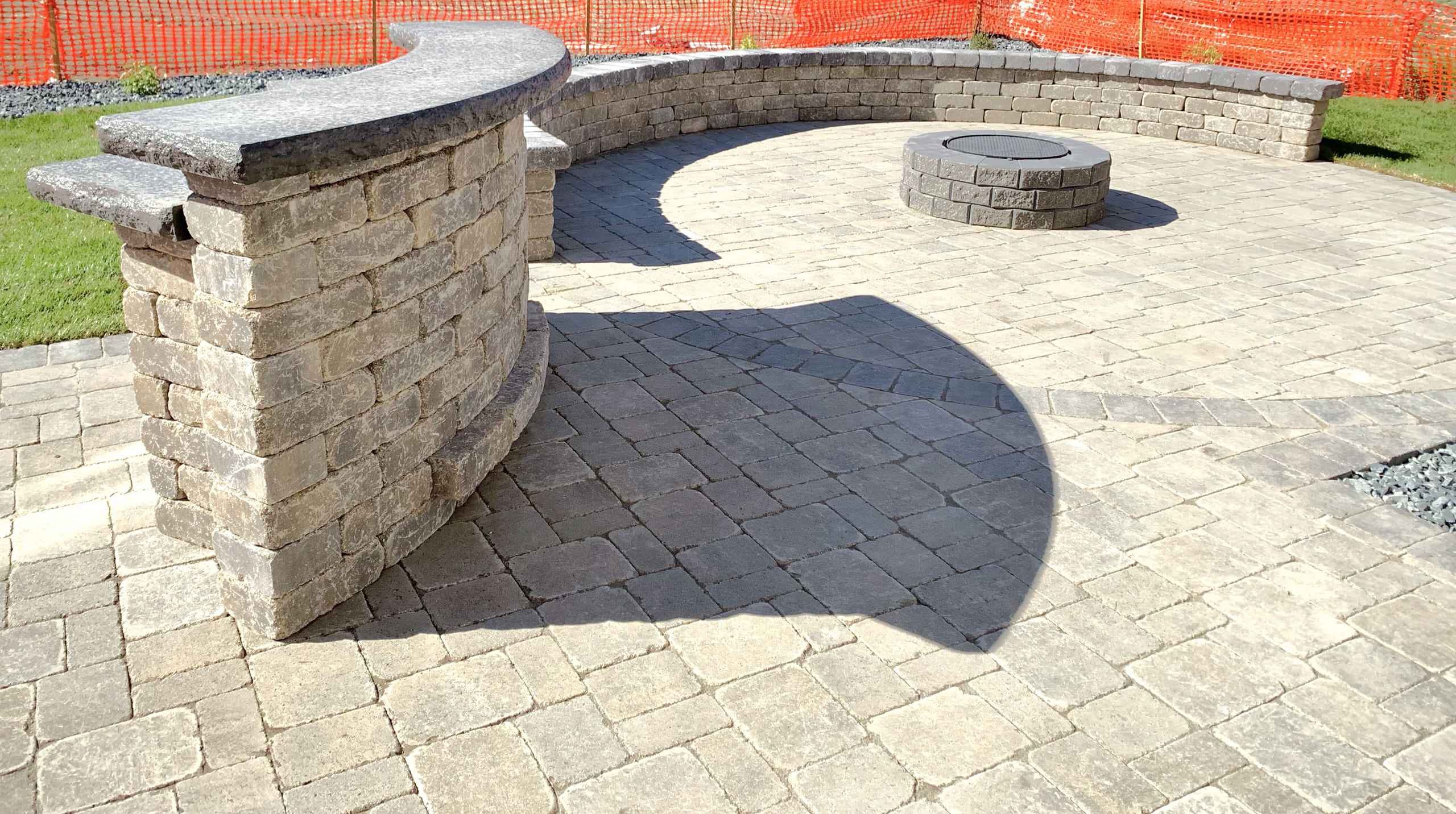 Step into "The Entertainer's Retreat," a stylish oasis that seamlessly merges elegance with functionality. Barkman Concrete roman pavers in sierra grey, complemented by a charcoal border, create a sop