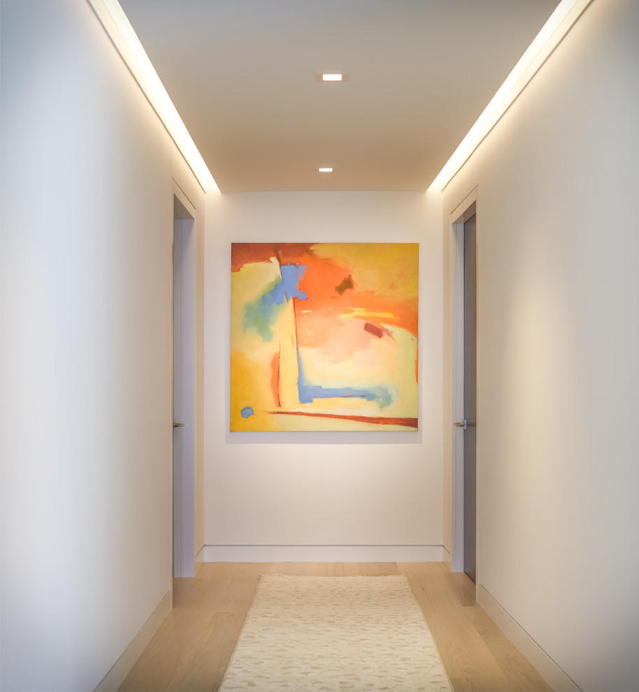 Inspiration for a contemporary hallway in Burlington with white walls.