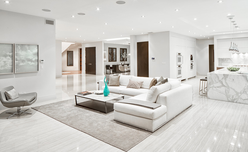 Expansive contemporary formal open concept living room in Los Angeles with white walls, porcelain floors and white floor.