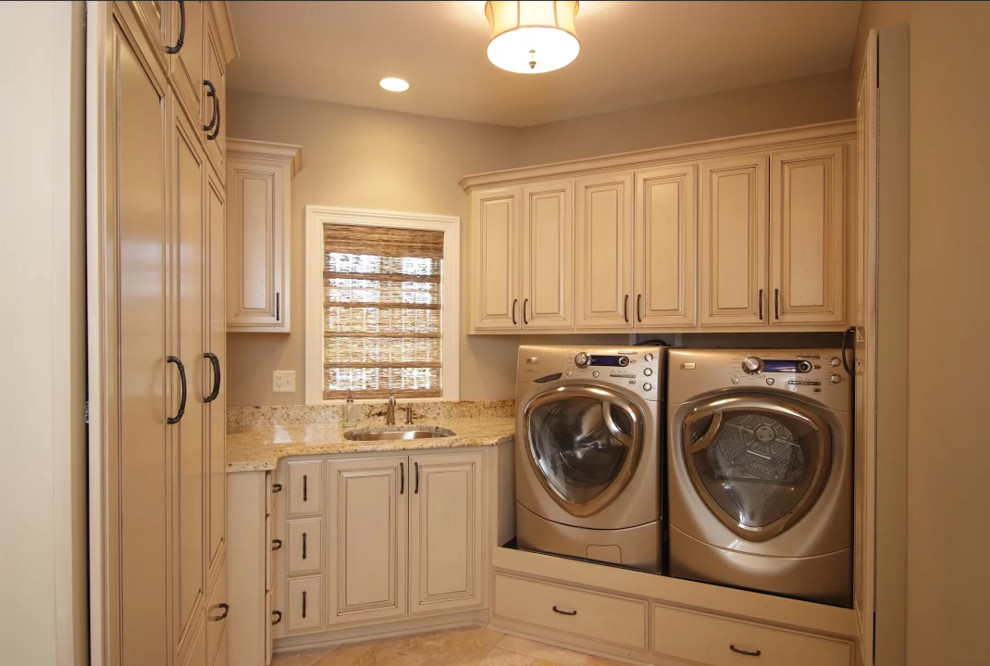 Inspiration for a mid-sized traditional u-shaped dedicated laundry room in Chicago with an undermount sink, raised-panel cabinets, white cabinets, granite benchtops, beige walls, ceramic floors, a side-by-side washer and dryer and beige benchtop.
