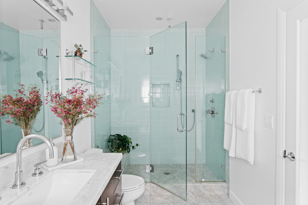 This is an example of a small transitional 3/4 bathroom in Los Angeles with flat-panel cabinets, dark wood cabinets, glass tile, white walls, marble floors, an undermount sink, marble benchtops, grey floor, white benchtops, a shower seat, a single vanity, a freestanding vanity, an alcove shower, blue tile and a hinged shower door.