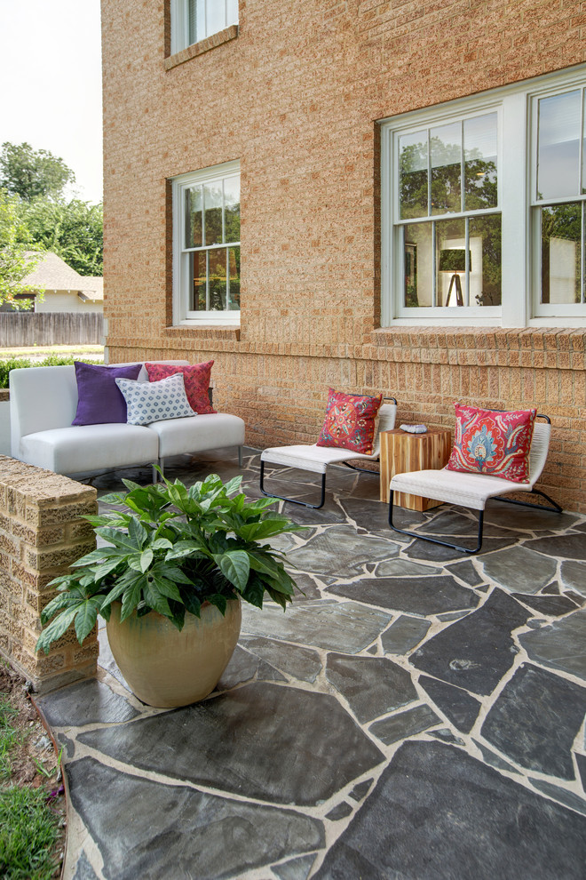 Inspiration for a mid-sized contemporary front yard patio in Oklahoma City with natural stone pavers and no cover.