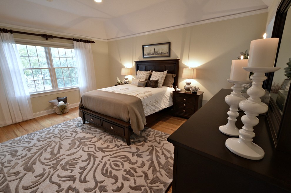 This is an example of a mid-sized traditional master bedroom in New York with grey walls and bamboo floors.