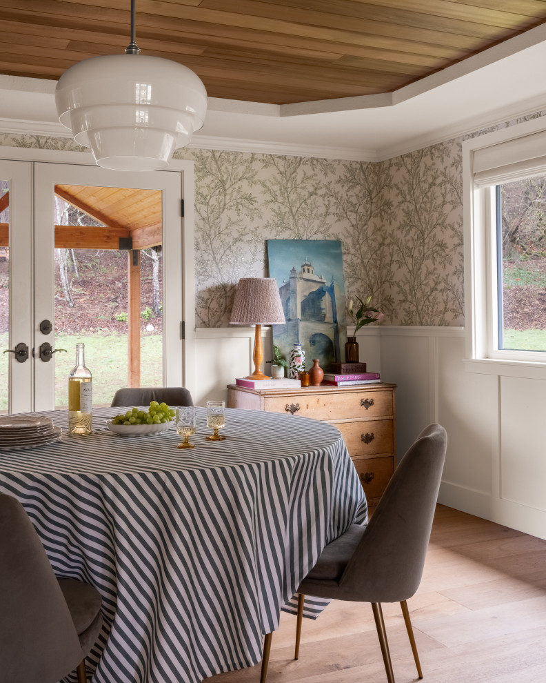 Transitional light wood floor, beige floor, tray ceiling, wood ceiling, wainscoting and wallpaper dining room photo in Seattle with multicolored walls