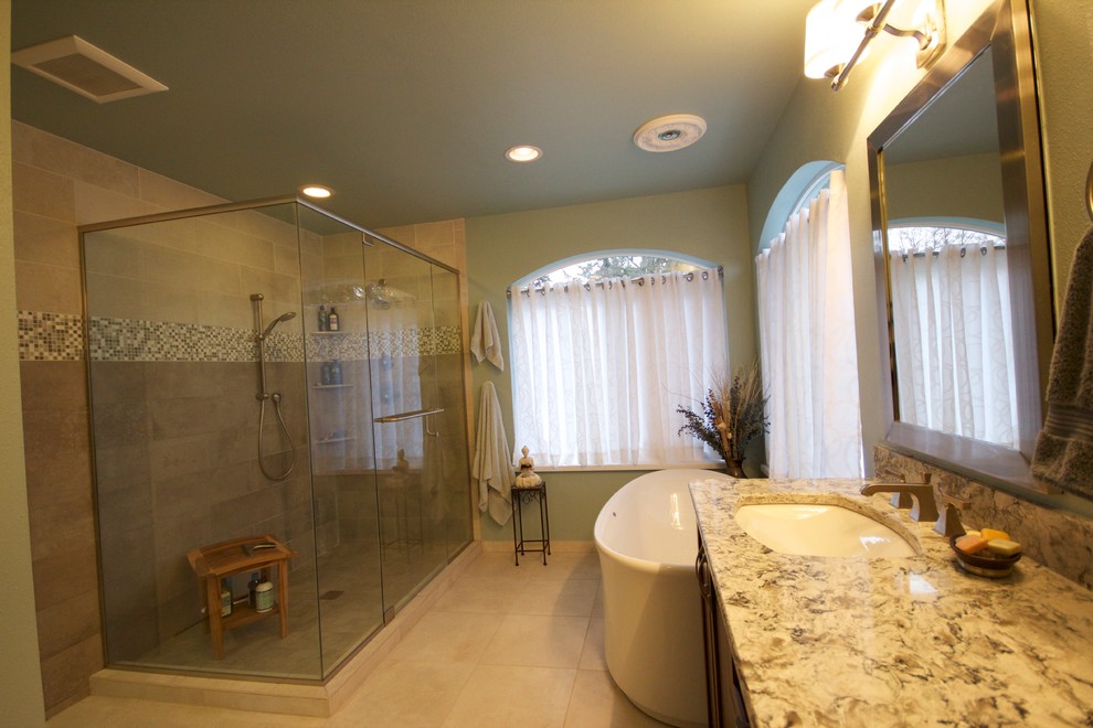 This is an example of a large traditional master bathroom in Seattle with an undermount sink, shaker cabinets, dark wood cabinets, engineered quartz benchtops, a freestanding tub, a corner shower, a one-piece toilet, multi-coloured tile, ceramic tile, green walls and ceramic floors.