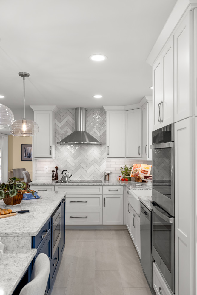 Kitchen - mid-sized transitional kitchen idea in DC Metro with shaker cabinets, white cabinets, quartz countertops, porcelain backsplash, stainless steel appliances and an island