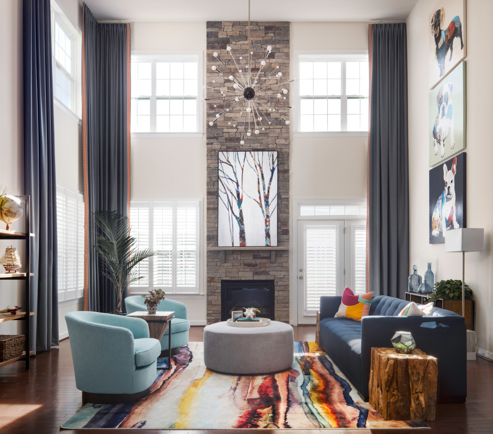 Example of a transitional medium tone wood floor and brown floor living room design in DC Metro with white walls, a standard fireplace, a stone fireplace and no tv