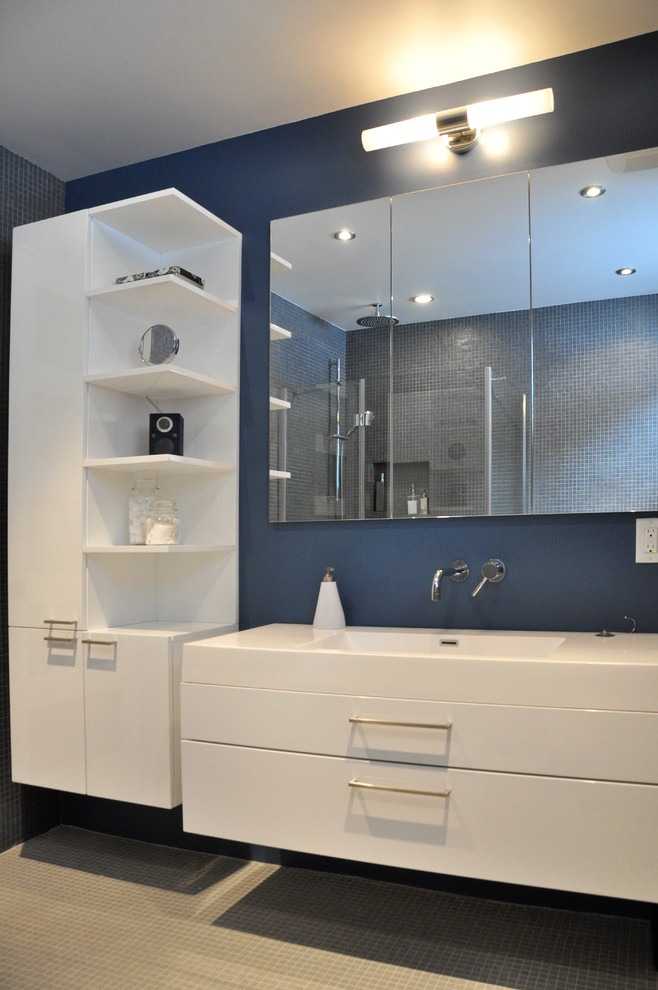 Design ideas for a modern bathroom in Montreal with a wall-mount sink, flat-panel cabinets, white cabinets and gray tile.