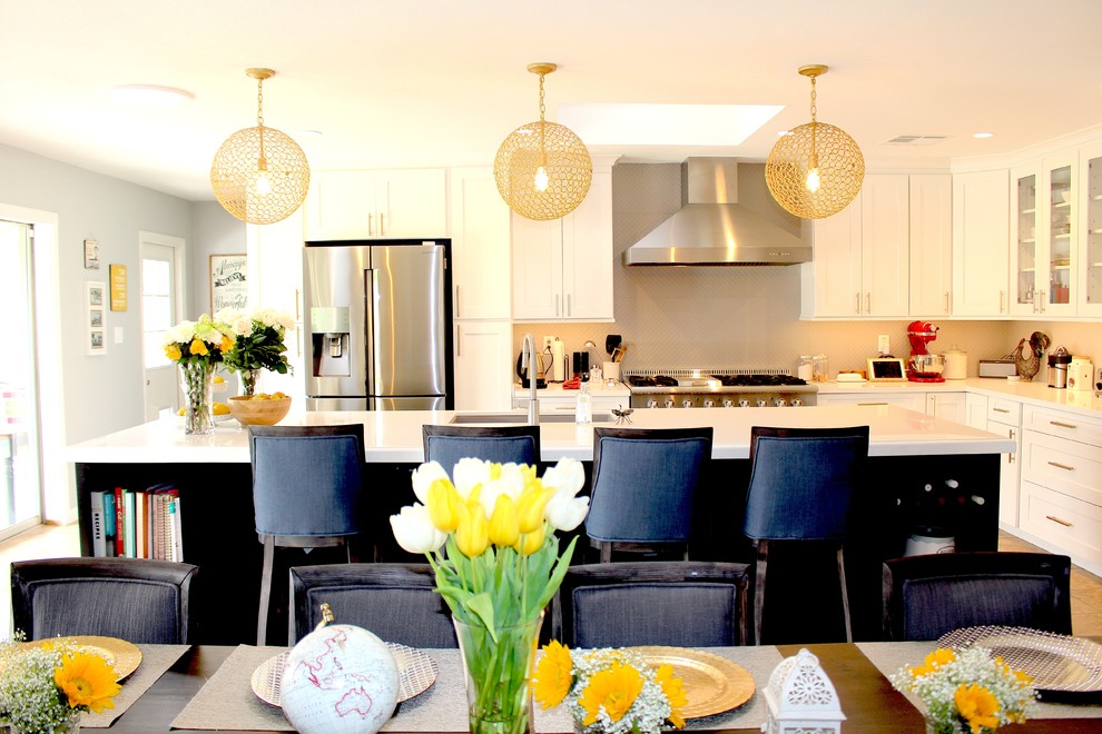 Example of a large transitional l-shaped ceramic tile and beige floor open concept kitchen design in Phoenix with an undermount sink, shaker cabinets, white cabinets, quartzite countertops, gray backsplash, stainless steel appliances and an island