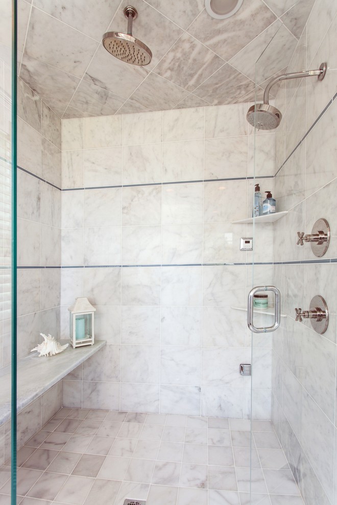 This is an example of a transitional master bathroom in Boston with an undermount sink, recessed-panel cabinets, white cabinets, marble benchtops, a double shower, gray tile, stone tile, white walls and marble floors.