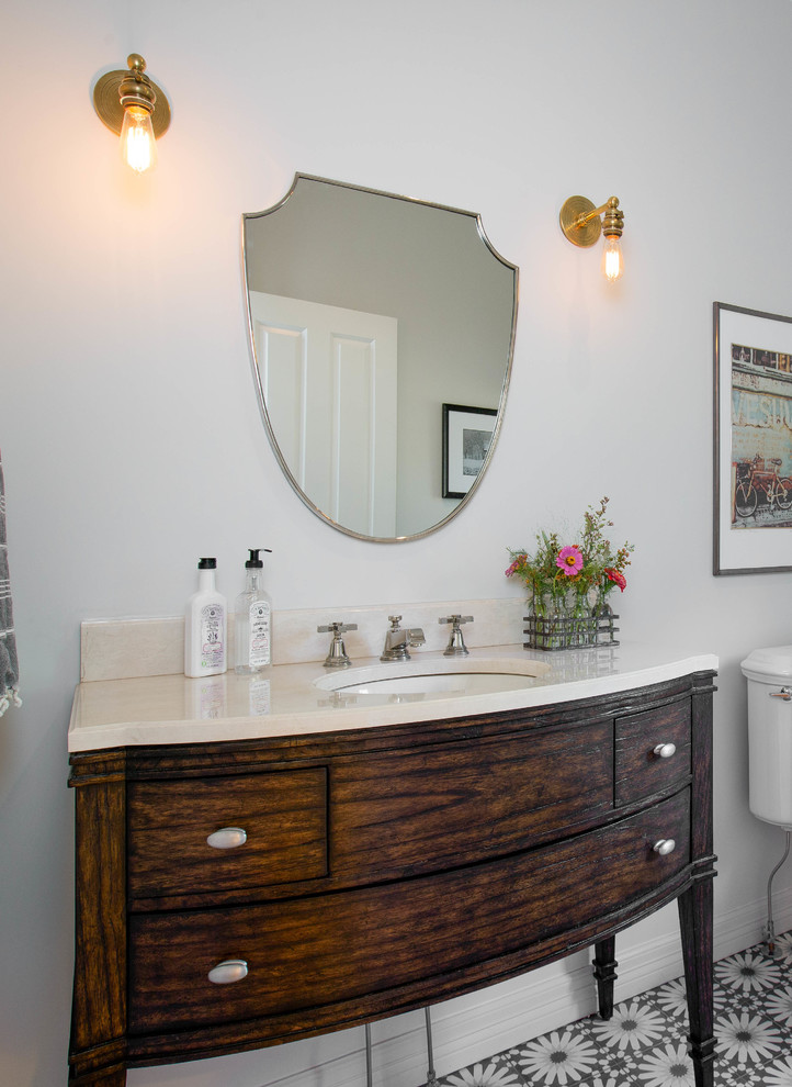 This is an example of a transitional powder room in Denver.