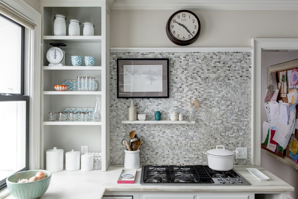 This is an example of a transitional eat-in kitchen in Other with open cabinets, white cabinets, grey splashback, mosaic tile splashback and with island.