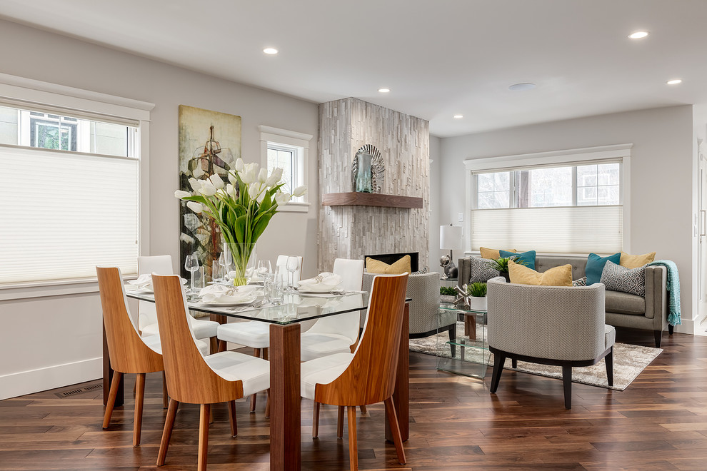 Photo of a mid-sized transitional open plan dining in Calgary with grey walls and medium hardwood floors.