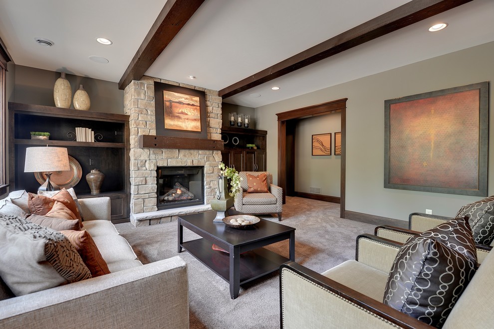 This is an example of a traditional living room in Minneapolis with beige walls, carpet, a standard fireplace and a stone fireplace surround.