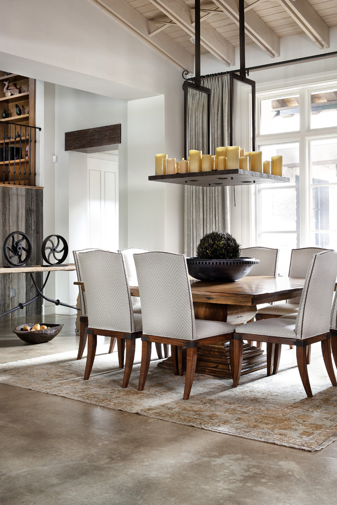 Inspiration for a mediterranean dining room in Austin with concrete floors.