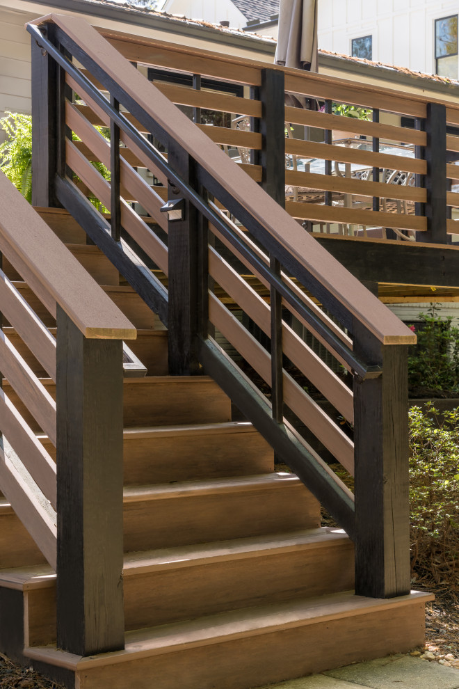Imagen de escalera minimalista de tamaño medio con barandilla de madera