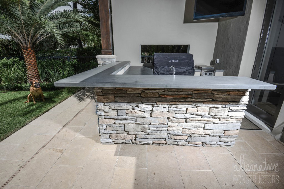 Design ideas for a tropical backyard patio in Miami with an outdoor kitchen and concrete slab.