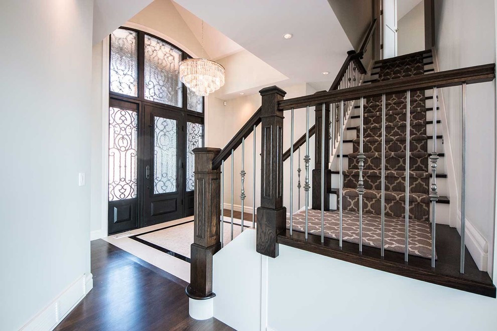 Large transitional porcelain tile and brown floor foyer photo in Calgary with gray walls and a metal front door