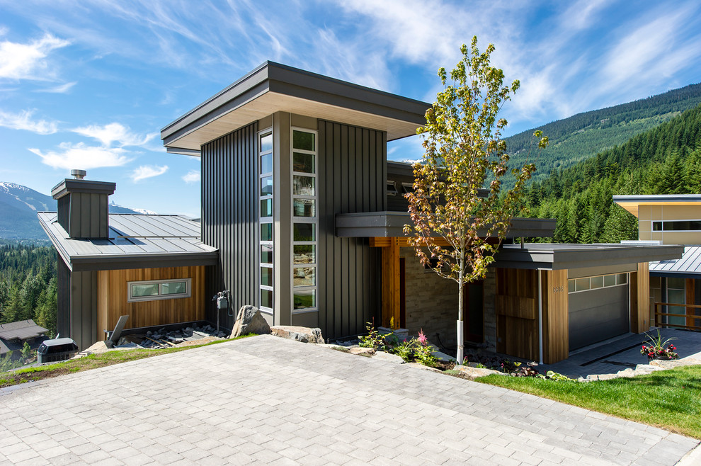 Design ideas for a contemporary split-level black exterior in Vancouver with mixed siding.