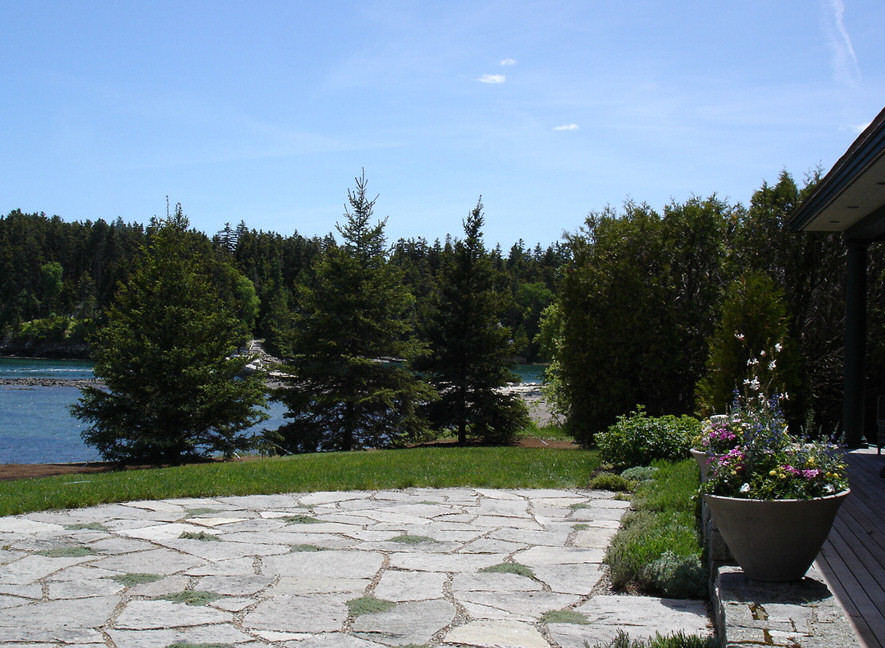 Mid-sized mountain style backyard stone patio photo